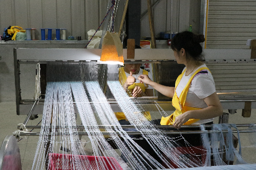 （深圳龙岗东西部扶贫协作 ）图为：那坡县同益新丝绸科技实业有限公司员工车间作业 （张臻斐 摄影 ）.jpg